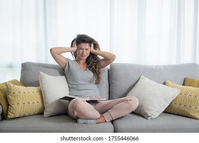 Young girl push her hands on her ears trying to not to hear the loud noise from neighbor apartment in building while they renovate the home and she cant study for school exam because of the noise - Shutterstock ID 1755446066