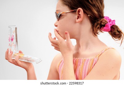 Young Girl Putting On Makeup From Compact