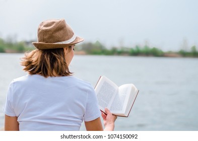 Young Girl Reading Book By Lake Stock Photo (Edit Now) 1074150092