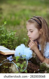 Young Girl Reading Book Outside