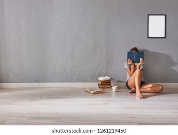 Young Girl Reading A Book In The Room, Frame Poster, Grey Stone Wall Background.