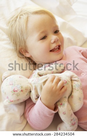 Similar – Little girl holding cookie sitting over the bed