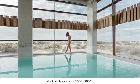 Young Girl Relaxing In Luxury Spa Hotel With Indoor Swimming Pool