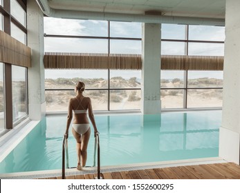 Young girl relaxing in luxury spa hotel with indoor swimming pool