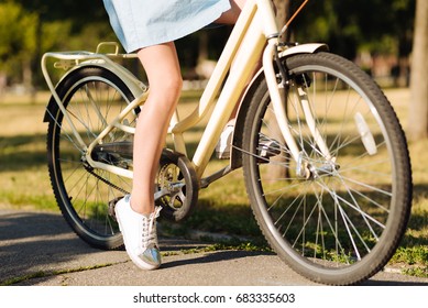 Young girl resting in the park with bicycle - Shutterstock ID 683335603