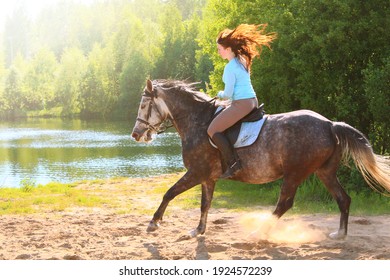 Young Girl Riding Fast On A Gray Horse