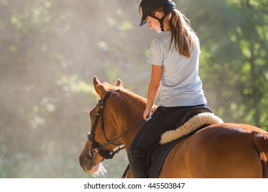 Young girl riding a horse  - Shutterstock ID 445503847