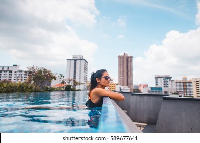 Young Girl In Rooftop Swimming Pool