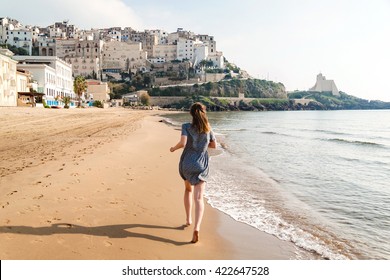 Young Girl Running On The Beach Of Sperlonga, Italy