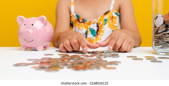 Young Girl Saving Money Picture Of A Girl Counting Money For Savings In A Glass.