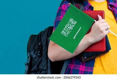 Young Girl With School Stuff Holds In Hand Saudi Arabia Flag Close Up