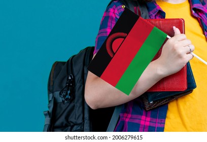 Young Girl With School Stuff Holds In Hand Malawi Flag Close Up