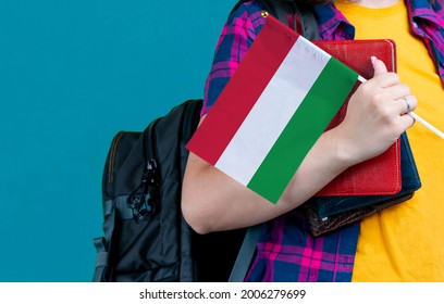 Young Girl With School Stuff Holds In Hand Hungary Flag Close Up