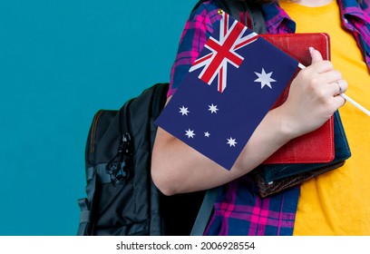 Young Girl With School Stuff Holds In Hand Australia Flag Close Up