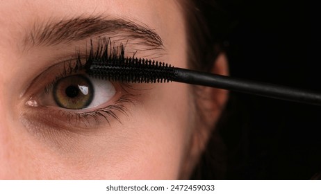 Young Girl Seen Applying Black Mascara To Her Eyelashes In A Close-Up Shot During A Professional Makeup Master Class