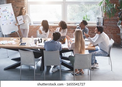 Young Girl Sharing New Business Ideas With International Colleagues During Meeting In Office