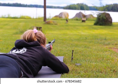 A Young Girl Shooting An Air Rifle At A Target.