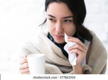Young girl sick in bed with temperature drinks hot  - Shutterstock ID 577861954