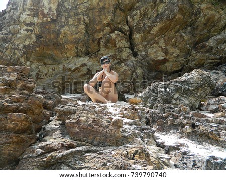 Similar – Beautiful young woman thinking and sitting on the rocks outdoors on the countryside