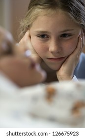 Young Girl Sitting By Hospital Bed