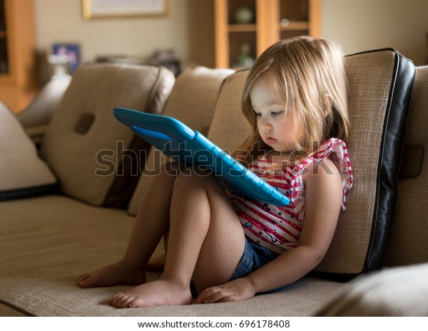 Stock photo of toddler looking at ipad
