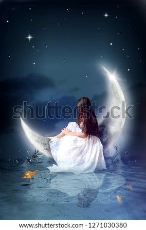 Young girl sitting on moon with water and goldfish under