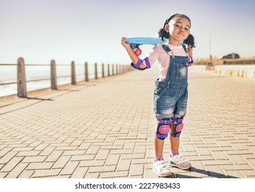 Young girl, skateboard and ocean walk of a child holding a board to skate by the beach. Kid portrait of a skateboarder with a grunge pose ready for summer activity, freedom and outdoor youth fun - Powered by Shutterstock