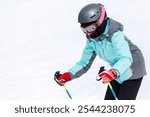 Young Girl Skiing Down a Snowy Slope in Bright Winter Gear on a Sunny Day.