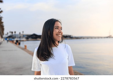 young girl smiling and looking the horizon
