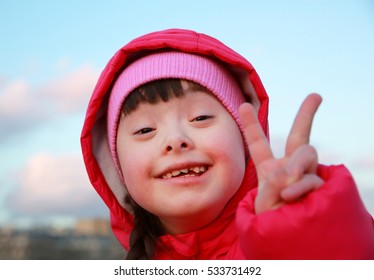 Young girl smiling on background of the blue sky