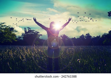 Young girl spreading hands with joy and inspiration facing the sun,sun greeting,freedom concept,bird flying above sign of freedom and liberty - Shutterstock ID 242761588