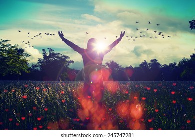 Young girl spreading hands with joy and inspiration facing the sun,sun greeting,freedom concept,bird flying above sign of freedom and liberty,heart bokeh 