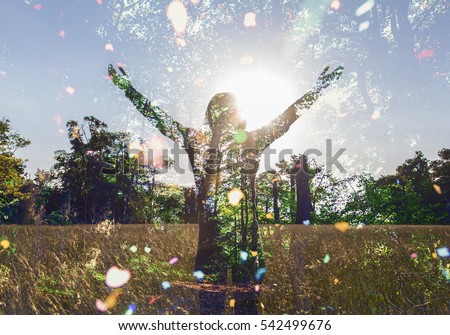 Young girl spreading hands with joy and inspiration facing the sun,sun greeting,freedom concept, nature lover ,spirit of forest 