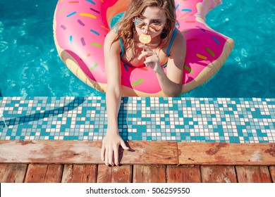 Young Girl In Sprinkled Donut Float At Pool 20s