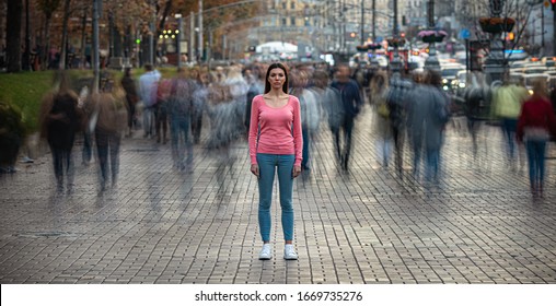 Das junge Mädchen steht auf der überfüllten Stadtstraße