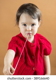 Young Girl Stretching A Chewing Gum From Her Mouth