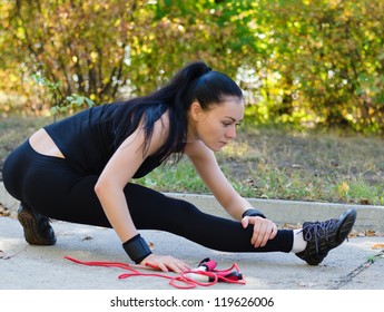 Young Girl Stretching Wearing A Black Leotard With Jumping Rope