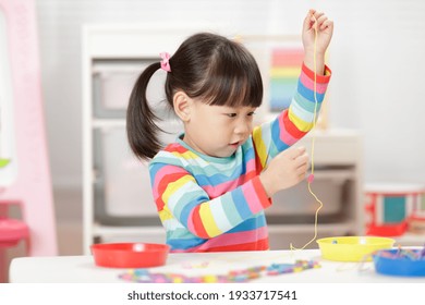 Young Girl String Wooden Bead Craft For Homeschooling