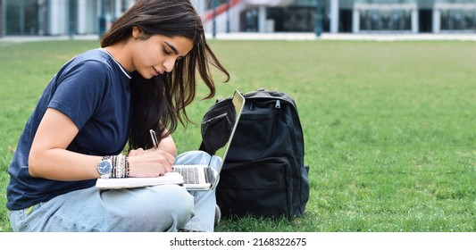 Young Girl Student Sitting On Grass Outside Using Laptop Computer