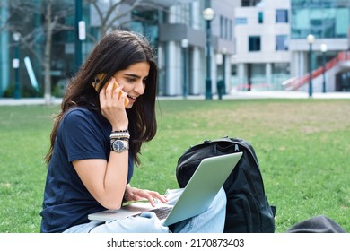 Young Girl Student Sitting On Green Grass Lawn Using Laptop Computer