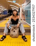 Young girl in stylish clothes in the subway. girl waiting for a train at the station. wait for a train. girl in the subway. fashion and style.