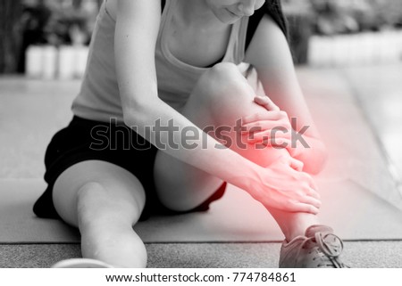 Young girl suffering or injury leg after do yoga.  russian woman or student has pain in his foot or shin while exercise or warm up. sport woman runner hurting holding painful sprained  ankle in pain