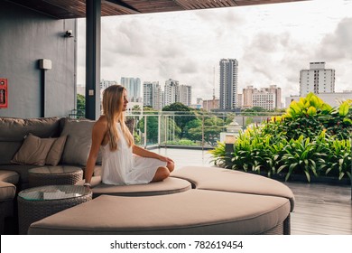 Young girl at the summer terrace on the rooftop of the Wangz hotel in Singapore. August 30, 2017