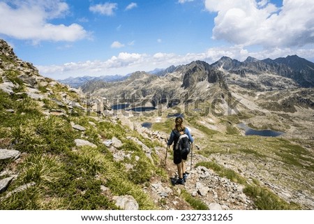 Young girl summit to Ratera Peak in Aiguestortes and Sant Maurici National Park, Pyrenees, Spain