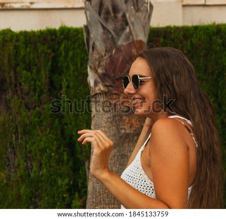 Similar – Brunette surfer woman with top and bikini holding surfboard