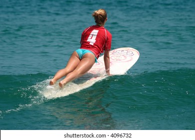 Young girl surfing on Malibu Beach, California