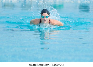 Young girl swimming butterfly stroke style - Powered by Shutterstock