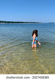 A Young Girl Swimming In The Calm Ocean Waters Of Noyack Bay In Sag Harbor. Long Beach Or Foster Memorial Beach Has White Sand, A Calm Surf, And A Beautiful View Of Greenport And Shelter Island.