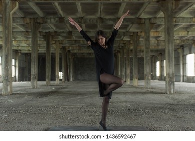 Young girl is sympathetic emotional doing exercises acrobatic movements, are in the premises of an old factory, warehouse, acro - Powered by Shutterstock