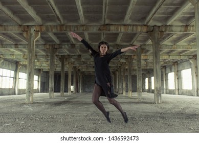 Young girl is sympathetic emotional doing exercises acrobatic movements, are in the premises of an old factory, warehouse, acro - Powered by Shutterstock